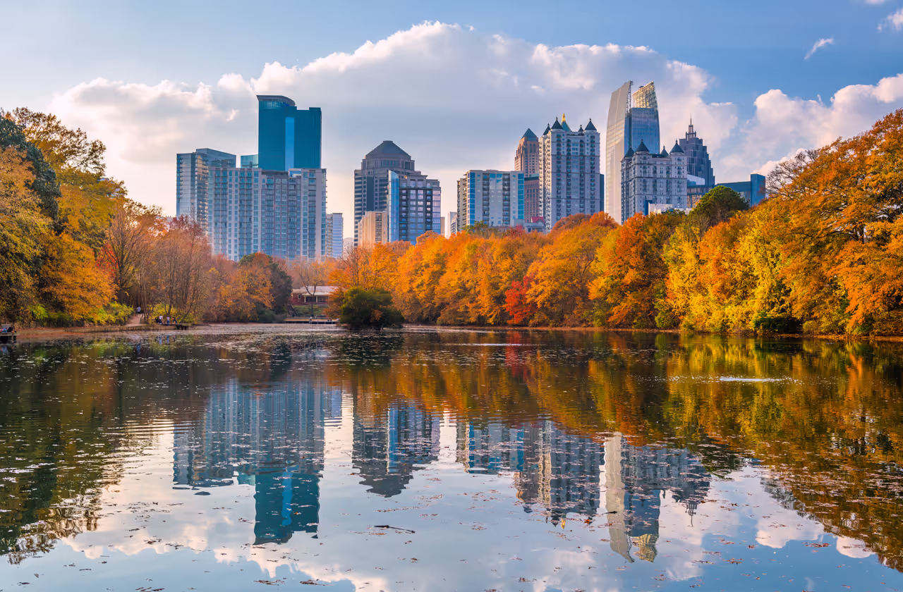 A city skyline reflected in a lake.