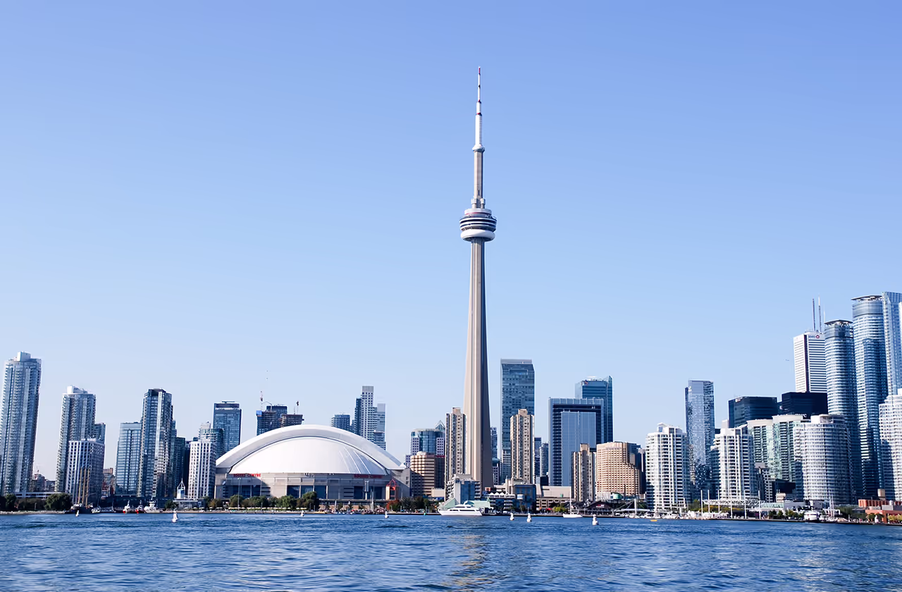 A large city skyline with a tall tower in the middle.